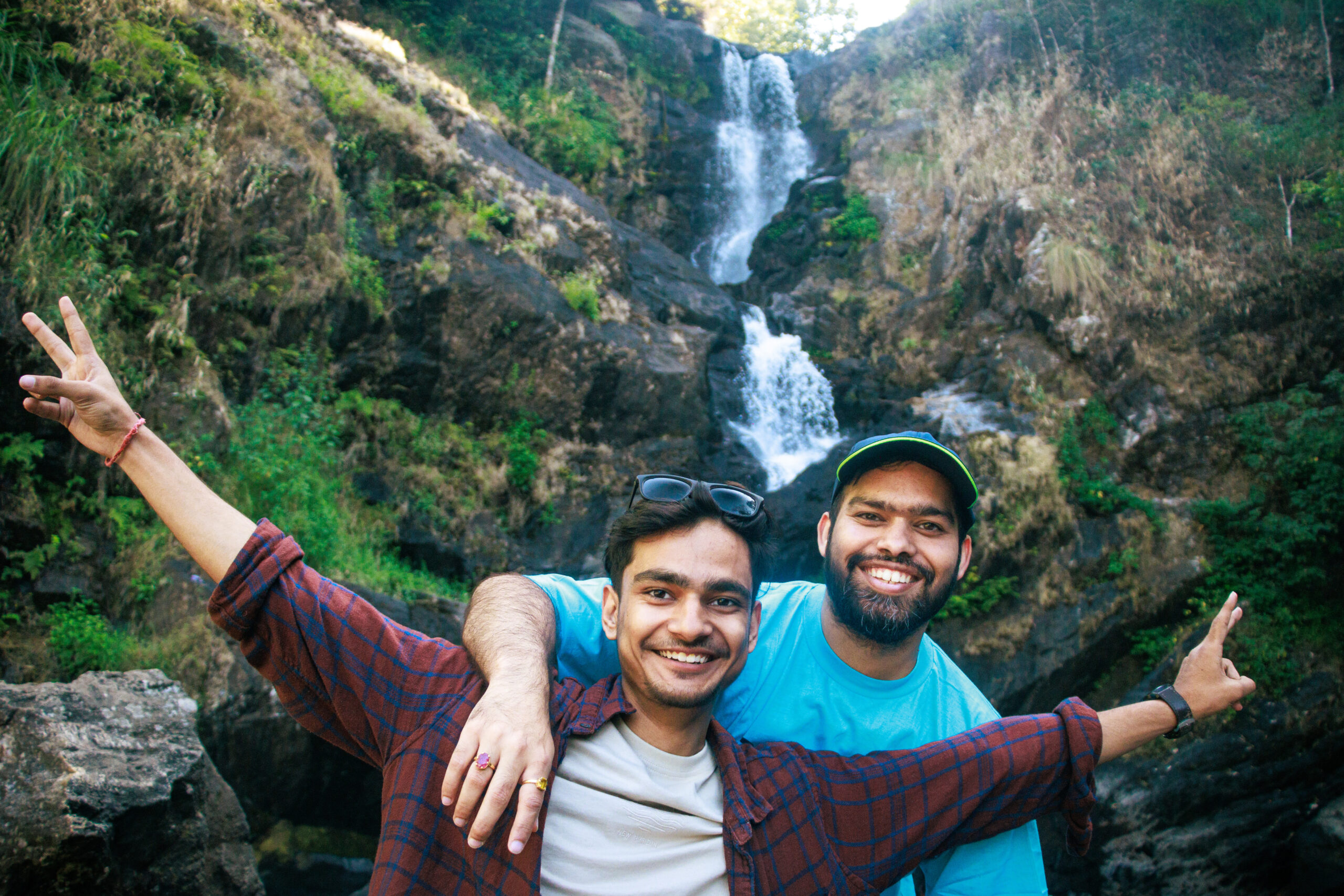 Group of travellers, tourist friends taking a selfie in front of Iruppu waterfalls in Coorg or Madikeri, Karnataka, India